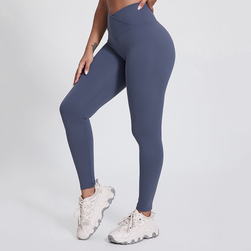 Gray V-Shaped High Waist Yoga Pants from The Infinite Shop shown from front side view with white sneakers.